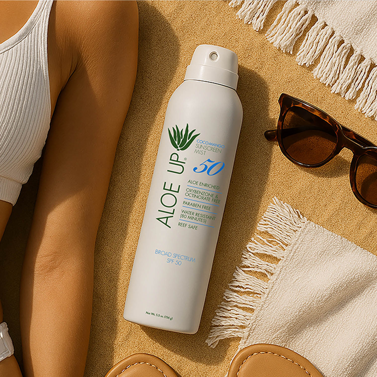 Aloe Up sunscreen spray at the beach on a sunny day