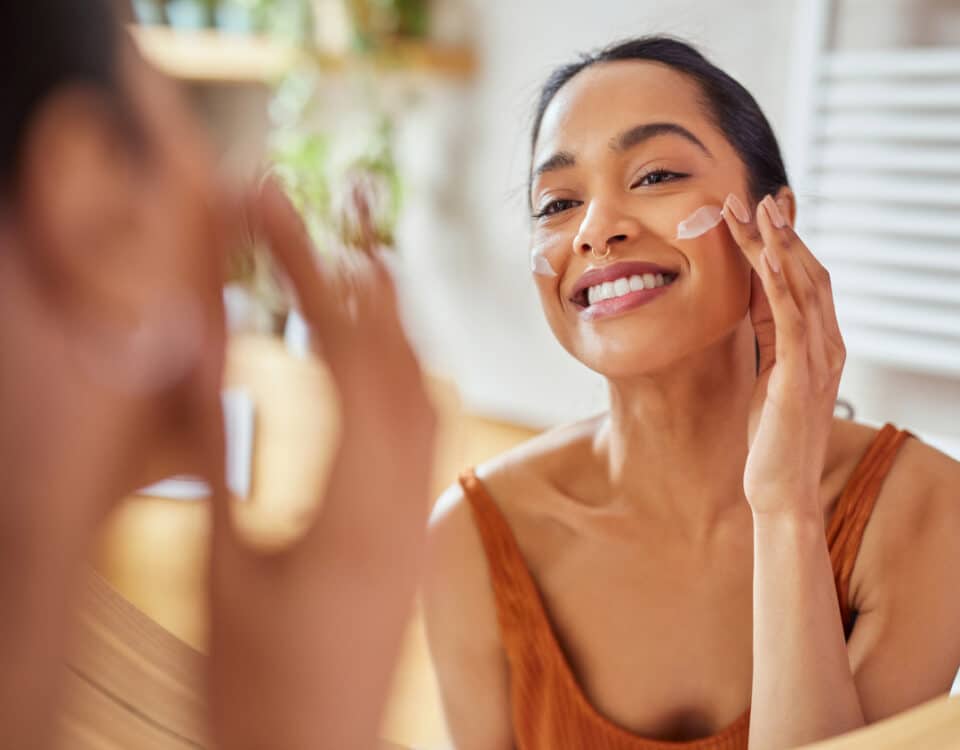 person applying suncreen lotion